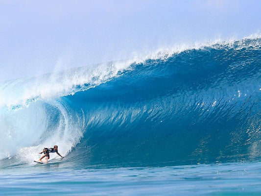 surfer pulling into a wave